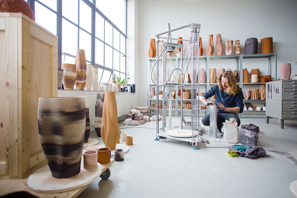 Olivier van Herpt working beside his ceramic 3D printer